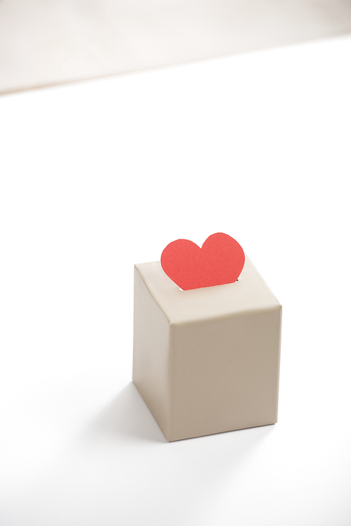 red heart in box on white background, donation concept