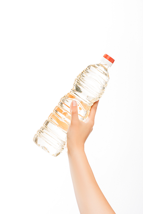 cropped view of woman holding bottle of oil isolated on white, charity concept