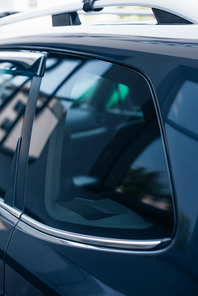 side window of black, modern polished car with reflection