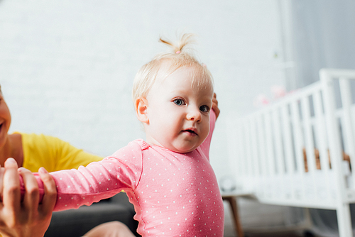 Selective focus of mother holding baby girl 