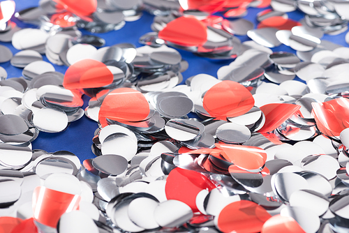 Selective focus of silver and red confetti background