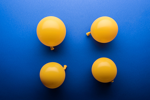 Top view of yellow balloons on blue background