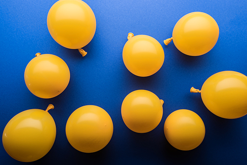 Decorative yellow balloons on blue bright background