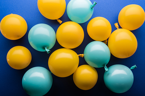 Top view of yellow and blue balloons festive background