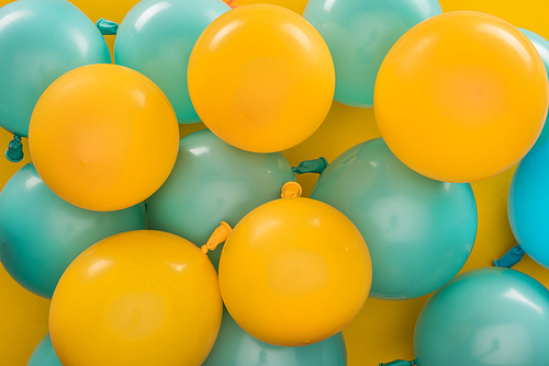 Yellow and blue balloons, party decoration on yellow background