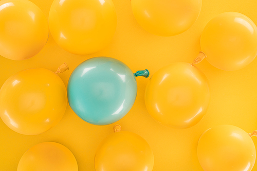 Yellow balloons and blue one on yellow background