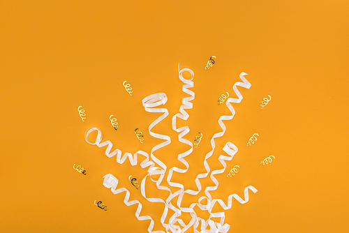 Top view of party decoration on orange background, surprise concept