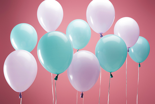 bright party multicolored balloons on pink background