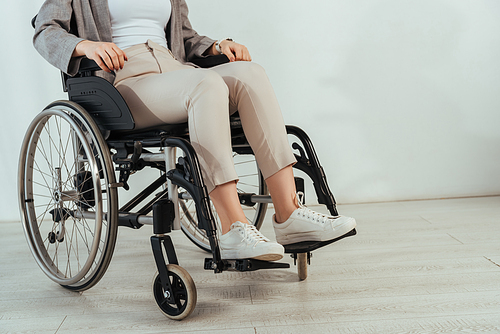 Cropped view of disabled woman on wheelchair on white background