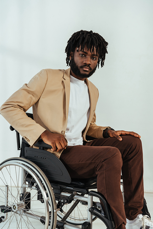 Disabled african american man on wheelchair on white