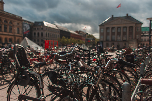 Selective focus of bicycles with sunlight on urban street in Copenhagen, Denmark