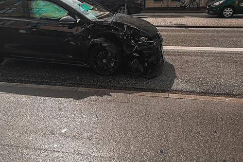 Broken car on road on urban street in Copenhagen, Denmark