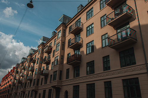 Low angle view of facade of house with cloudy sky at background, Copenhagen, Denmark