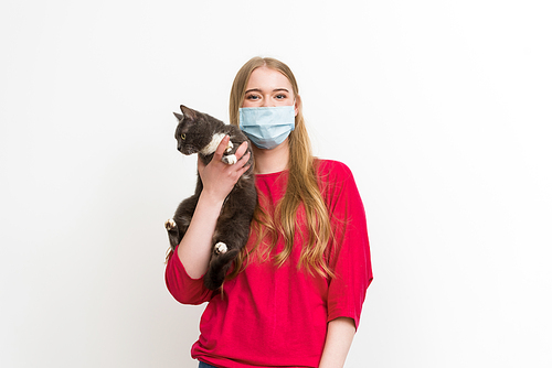 young woman in medical mask holding in arms cute cat and  isolated on white