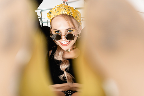 selective focus of fashionable woman posing in shopping cart