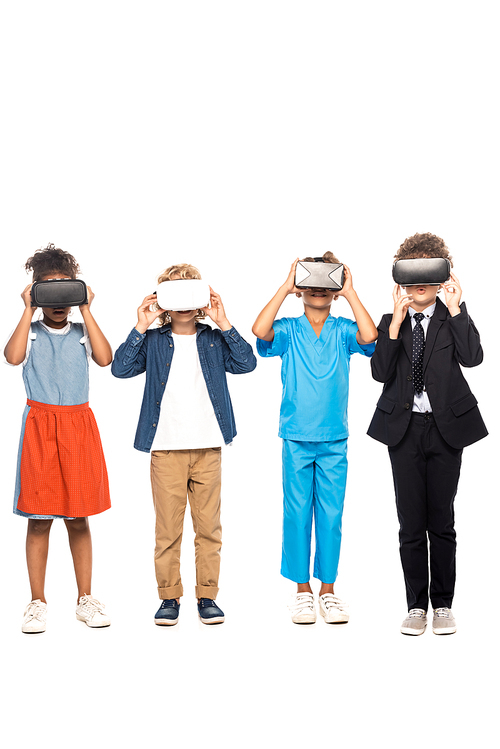 multicultural children dressed in costumes of different professions touching virtual reality headsets isolated on white