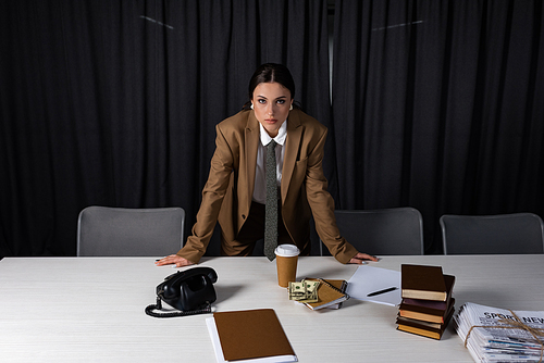 adult businesswoman standing behind table in office, 