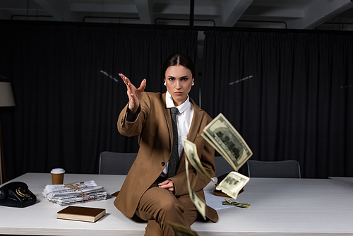 businesswoman sitting on table, throwing money and 
