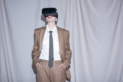 young model in vr headset standing on curtain background