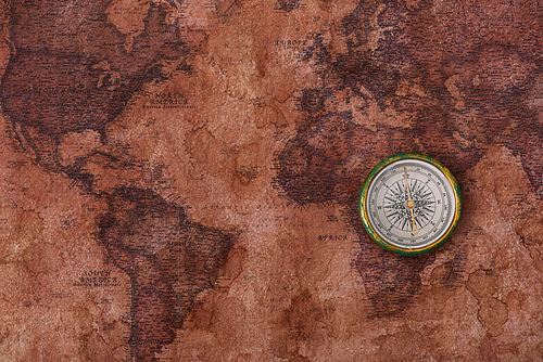 top view of compass on old world map