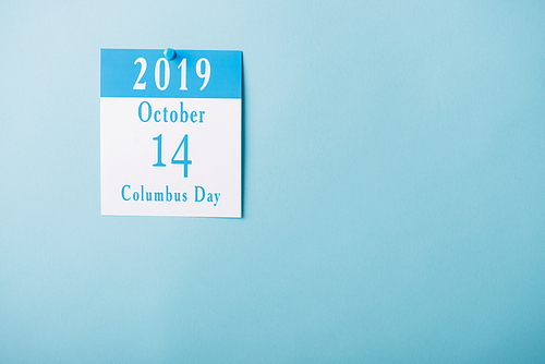 paper calendar with Columbus Day inscription isolated on blue