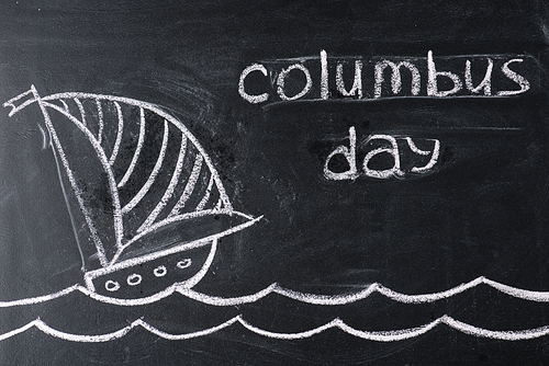 chalkboard with ship drawing and Columbus Day inscription