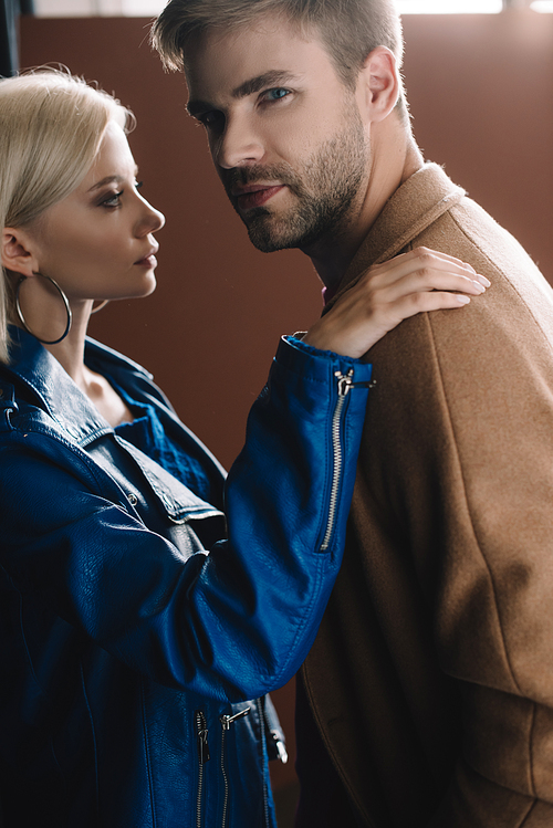 stylish young woman and man in autumn clothes