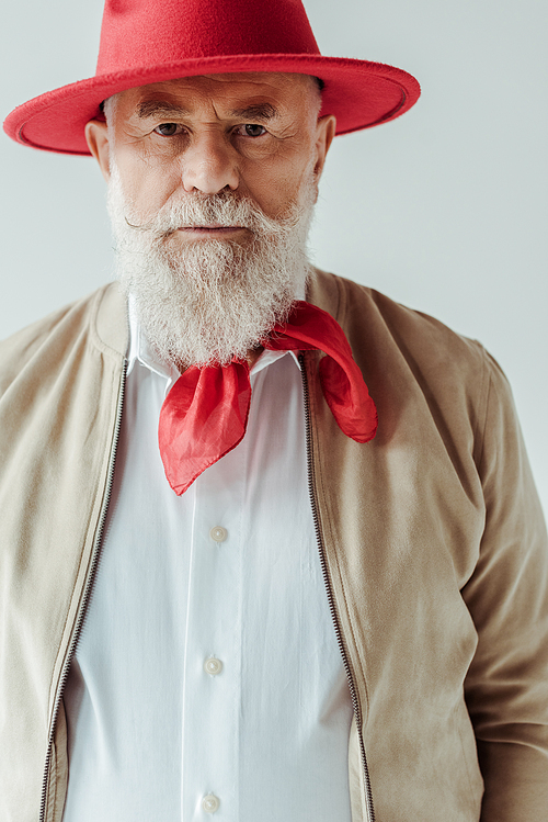 Handsome senior man in red hat  isolated on grey