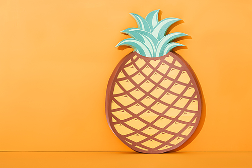 paper artwork pineapple on orange with copy space, summer concept