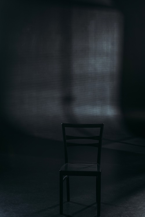 chair on dark background with lighting, suicide prevention concept
