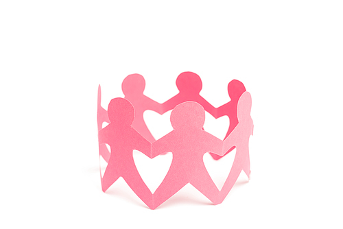 Pink paper figures of people holding hands on white background
