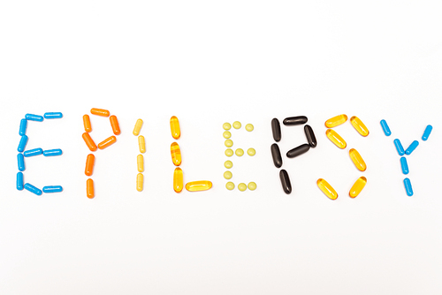 Top view of lettering epilepsy from colorful pills isolated on white