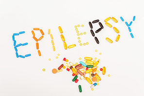 High angle with of epilepsy lettering near pills on white background