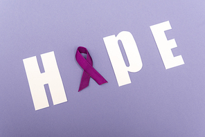 High angle with of word hope with purple ribbon isolated on purple