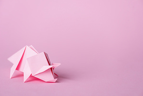 small paper rhinoceros on pink with copy space