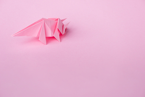 decorative origami rhinoceros on pink with copy space