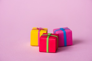 selective focus of paper gift boxes on pink