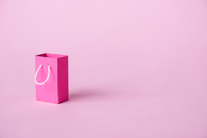 small shopping bag on pink with copy space