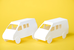 white paper cars on yellow with copy space