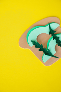 top view of paper avocado sandwich isolated on yellow