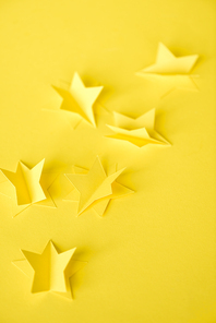 selective focus of paper stars on yellow