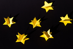 decorative yellow paper stars isolated on black
