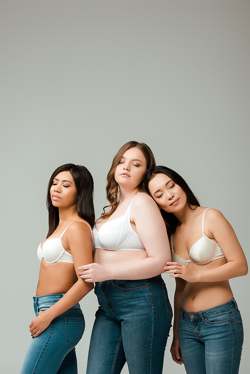 Multiethnic women with closed eyes isolated on grey