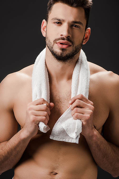 handsome naked man with towel isolated on black