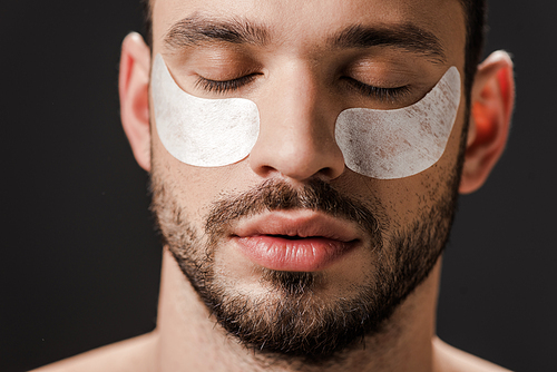 handsome man with eye patches on face isolated on grey