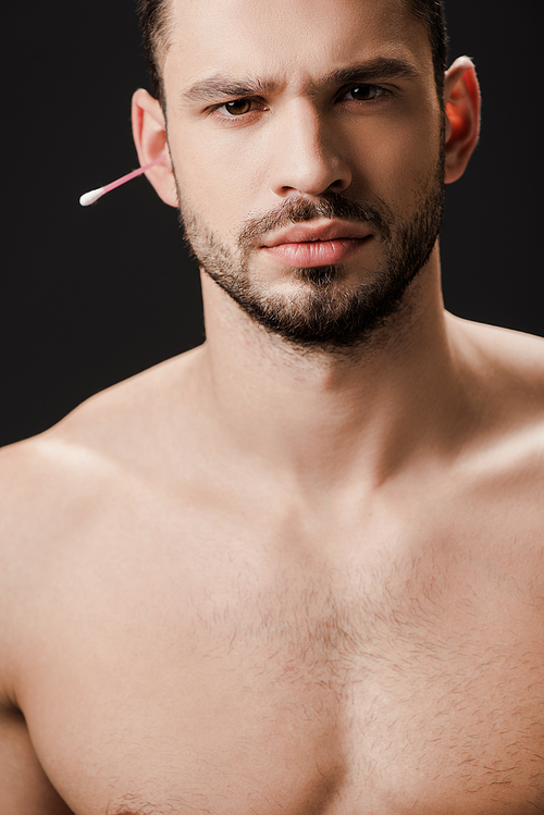 handsome naked man with ear swab isolated on black