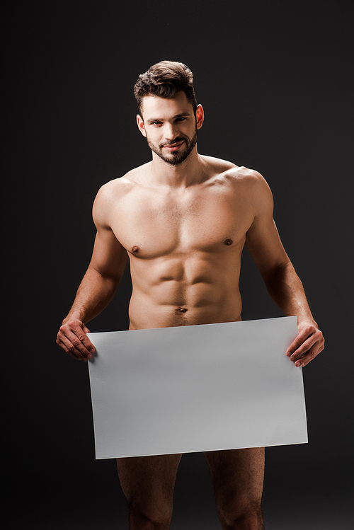 happy sexy naked man holding blank placard isolated on black