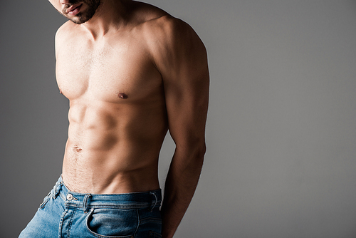 cropped view of sexy shirtless man in jeans isolated on grey