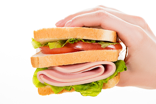 cropped view of woman holding fresh delicious sandwich with sliced sausage and lettuce isolated on white