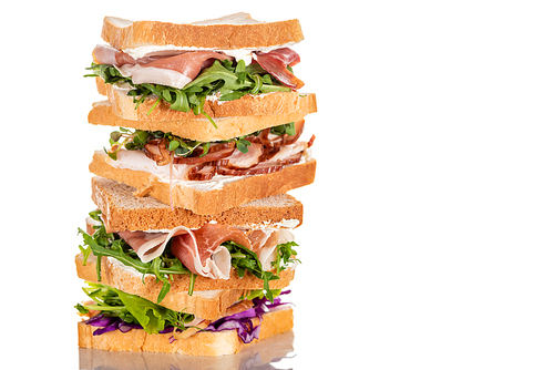 fresh sandwiches with arugula and meat on white surface